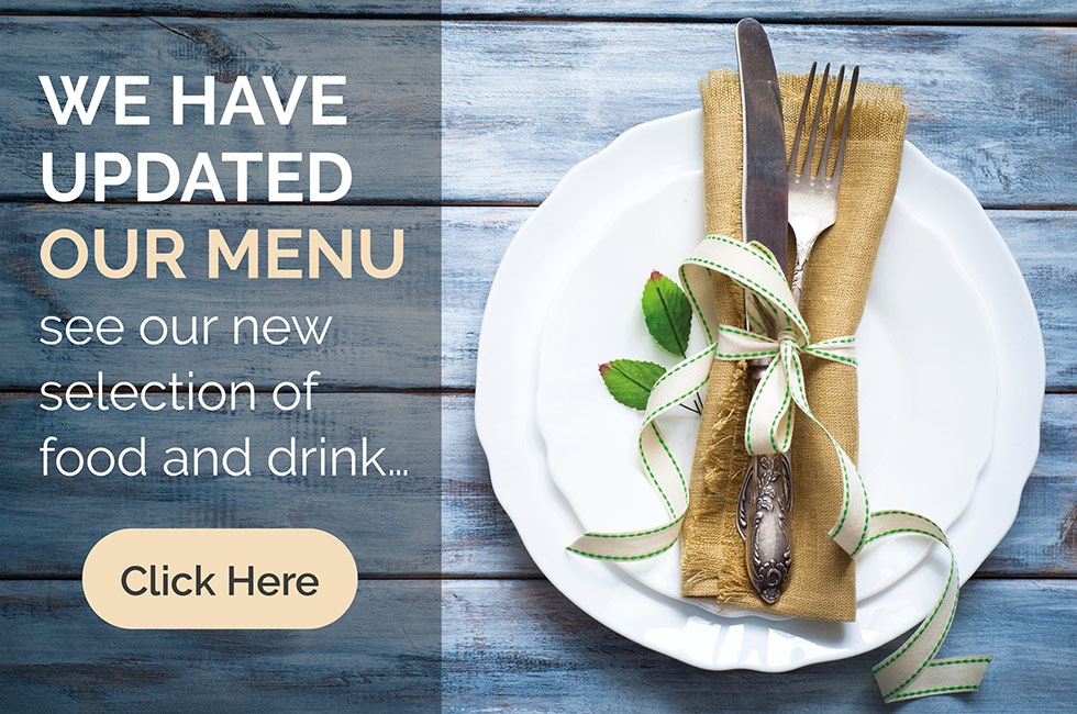 Photograph of a white plate and silver cutlery on a blue wooden table advertising the updated menu at The Sackville Bistro restaurant
